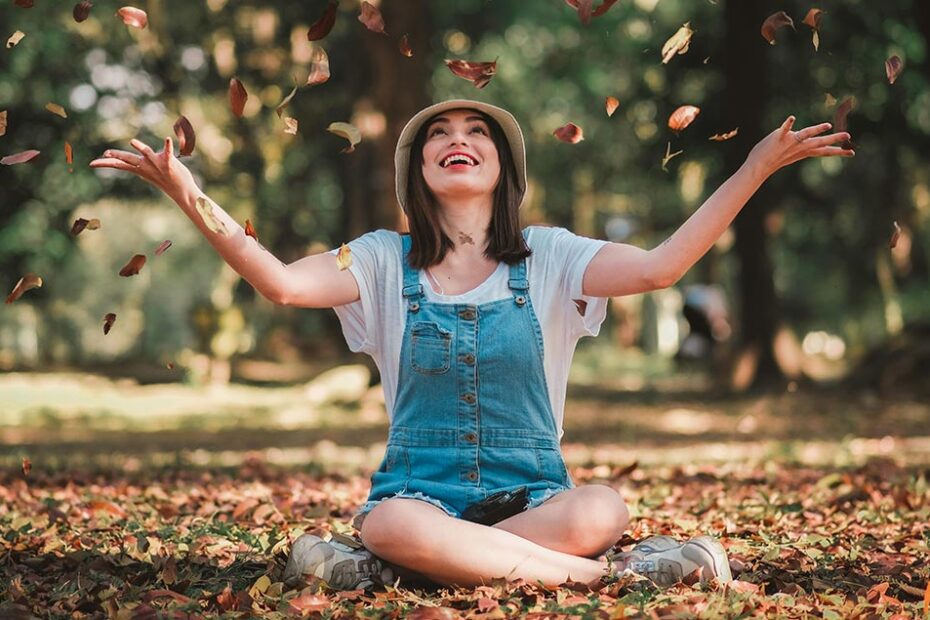 How to Love Yourself Again : A girl throwing leaves and feeling happy